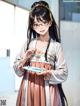 A woman in a kimono holding a plate of food.