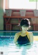 A woman in a swimming pool smiling at the camera.